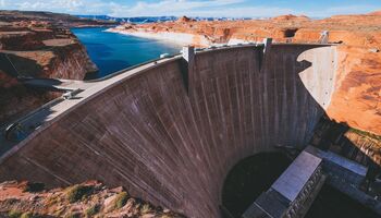 Aerial view of a large grey concrete dam