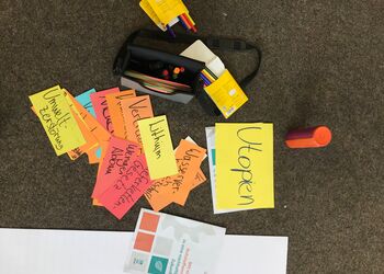 Auf dem Boden liegen viele Moderationskarten aus einem Workshop. Die Begriffe Utopien, Lithium, Lieferkettengesetz, weniger Abbau und Umweltzerstörung sind zu lesen.